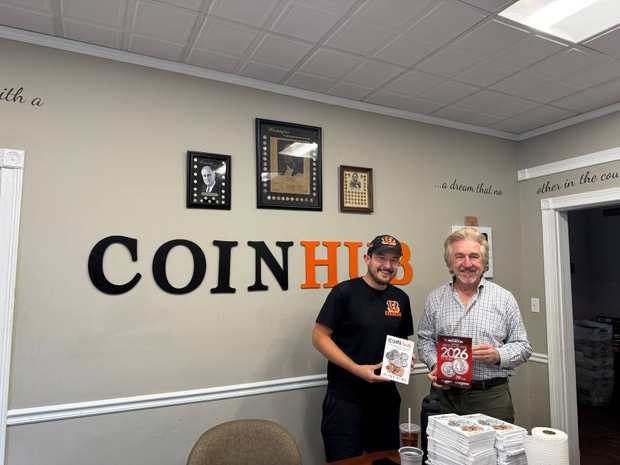 Blake Alma and numismatic author Jeff Garrett holding coin publications at CoinHub